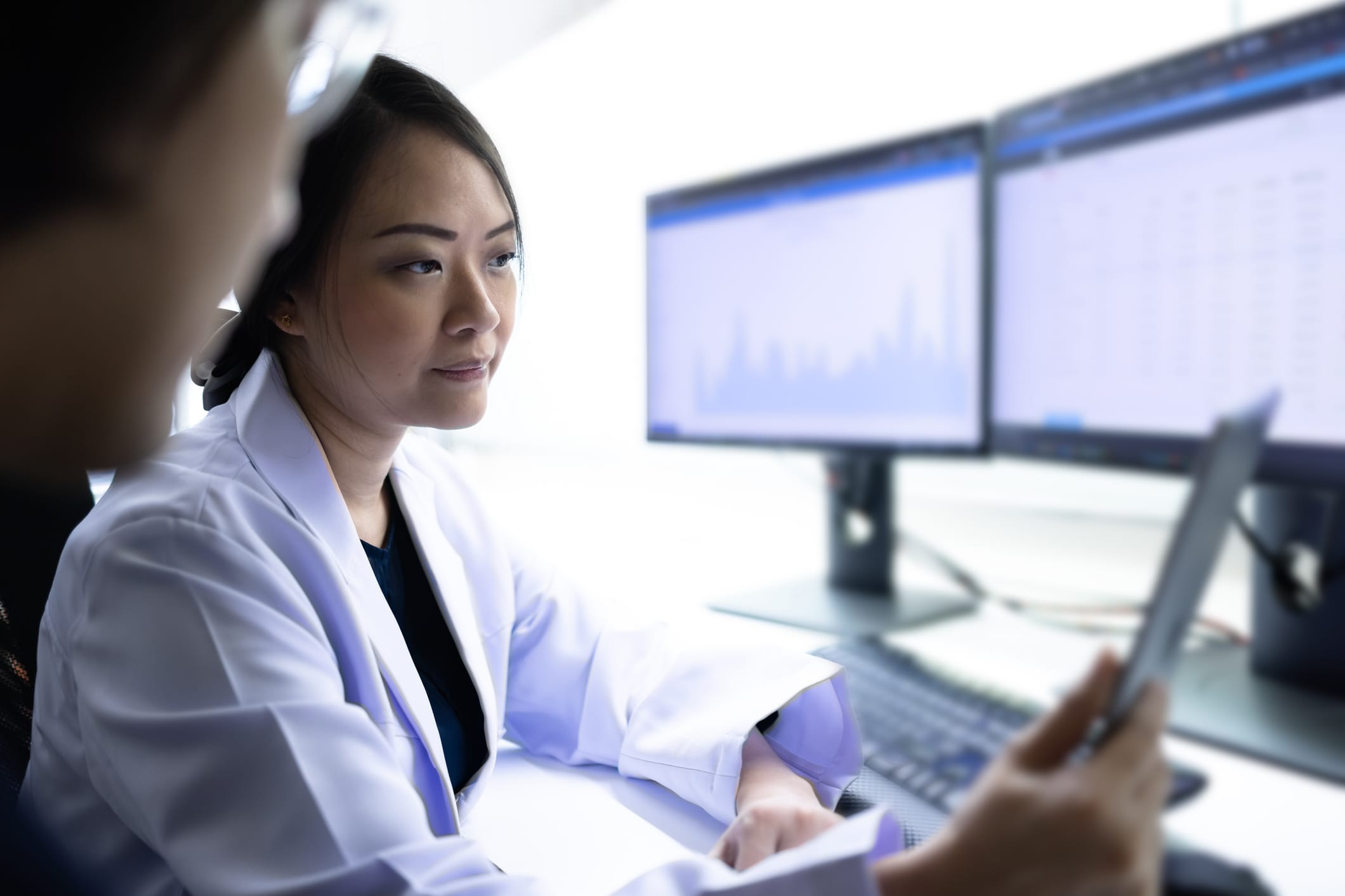 Researchers looking at data on a monitor
