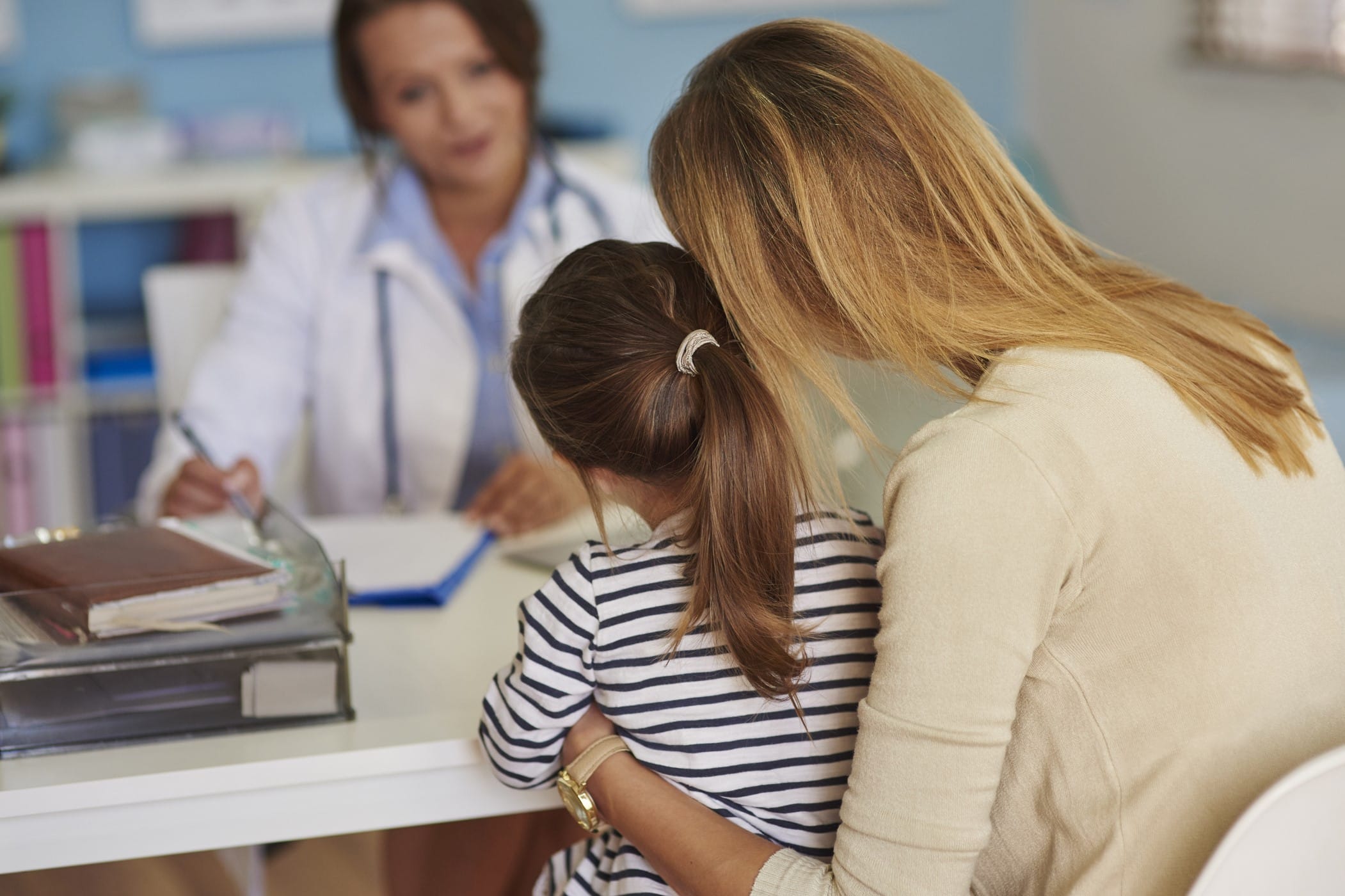 Mother and child speaking with a doctor