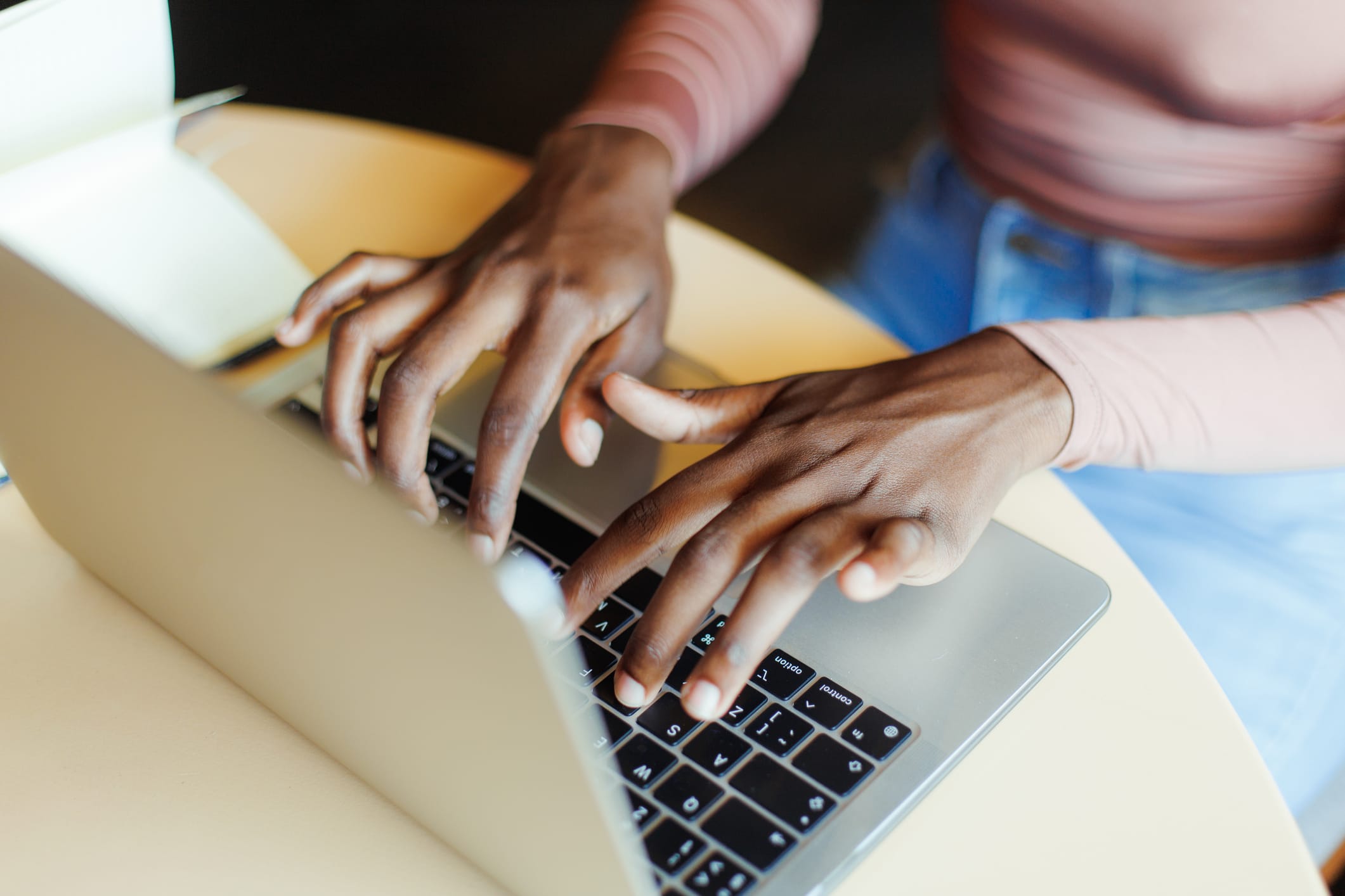 Woman writing on laptop