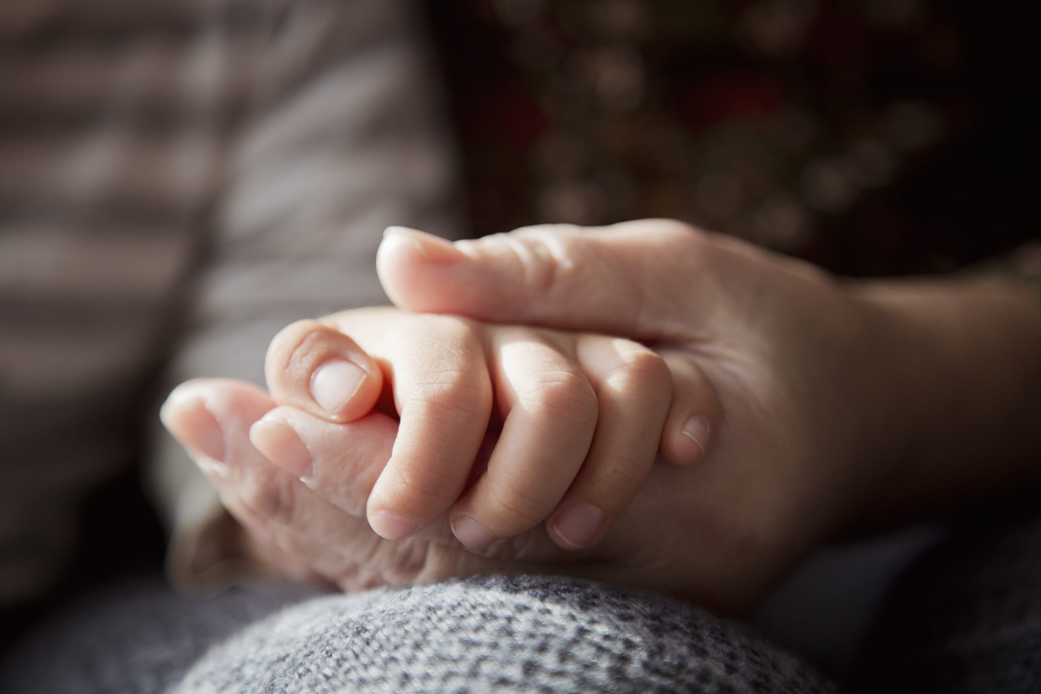 Older person holding a child's hand