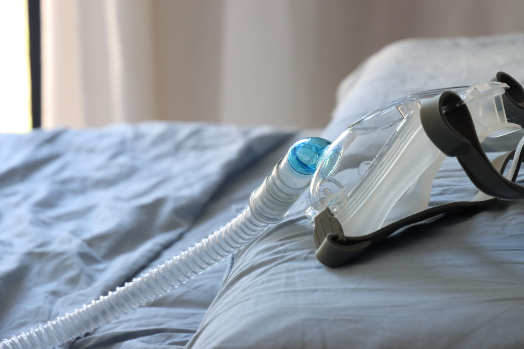 BiPAP face mask on a bed